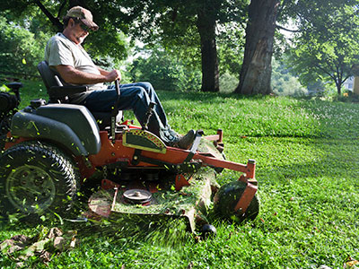 Man on riding Lawn Mower - Lawn Mowers in Greenville, NC